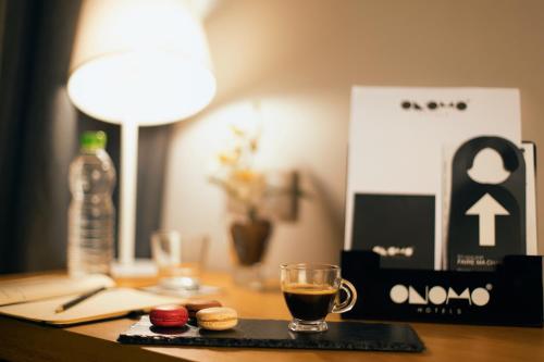 a desk with a cup of coffee and a drink at ONOMO Hotel Casablanca City Center in Casablanca