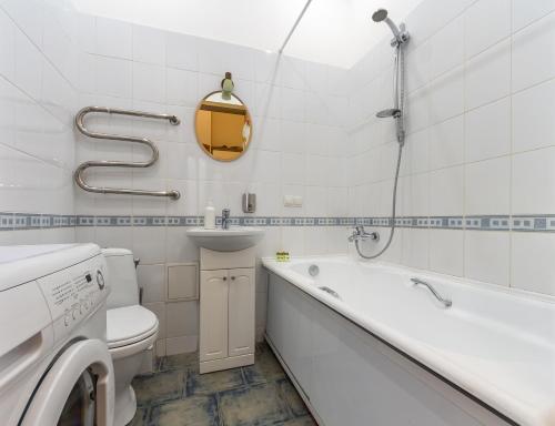a bathroom with a toilet and a tub and a sink at DayFlat Apartments Golden Gate Area in Kyiv
