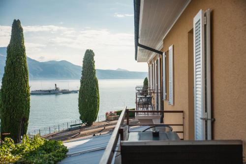 a balcony with a view of the water at Auberge de Rivaz in Rivaz