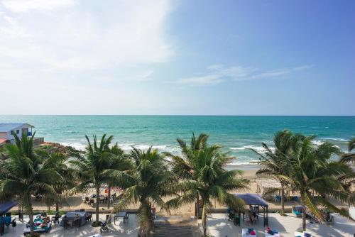 a view of a beach with palm trees and the ocean at Palmazul Hotel & Spa in San Clemente