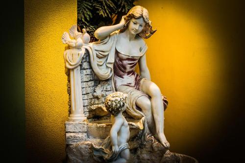 a statue of a woman and a child sitting on a statute at Hotel Libertador in Santiago