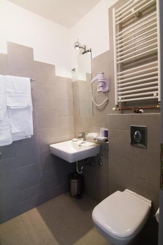 a bathroom with a sink and a toilet at Garden Hotel in Zagreb
