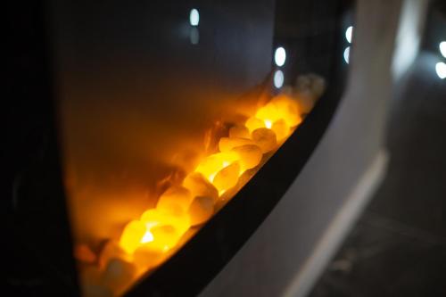 a row of yellow candles in a fireplace at Comfort Zone Naples in Naples