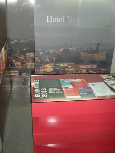 a red table with a sign that reads hotel dont lo at Hotel Dom Joao IV in Guimarães