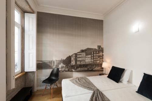 a bedroom with a white bed and a window at naBaixa Apartments in Porto