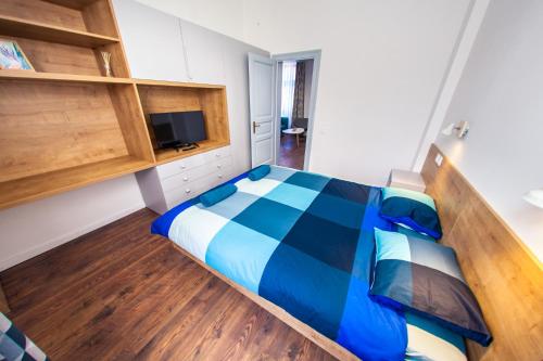 a bedroom with a bed and a television in it at Central Luxury 1 in Cluj-Napoca