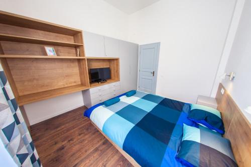 a small bedroom with a bed and a tv at Central Luxury 1 in Cluj-Napoca