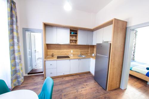 a small kitchen with a refrigerator and a bed at Central Luxury 1 in Cluj-Napoca