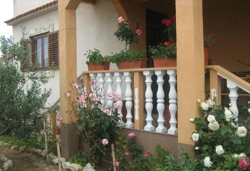 a house with potted plants on a balcony at Studio Apartment in Nin with Balcony, Air Conditioning, Wi-Fi (3718-2) in Nin