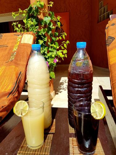 a table with three bottles and two glasses of juice at Safari Village Saly V 225 in Saly Portudal