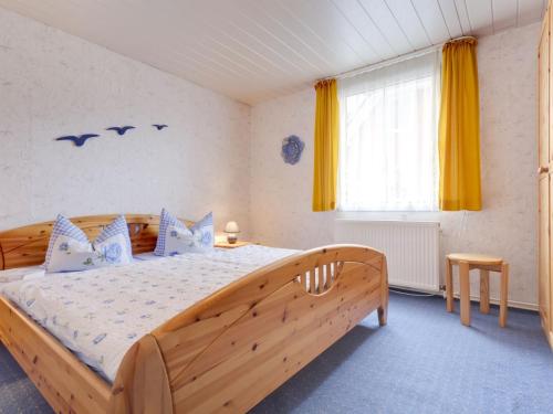 a bedroom with a wooden bed and a window at Tranquil Holiday Home in Zingst Germany with Terrace in Zingst