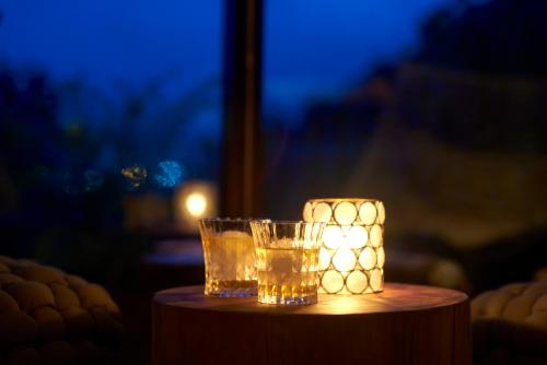 a glass of tea and a candle on a table at Fufu Kawaguchiko in Fujikawaguchiko