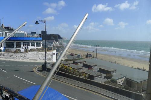 a view of a beach and the ocean from a bus at Royal Pier in Sandown