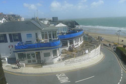 a building on the side of a beach with the ocean at Royal Pier in Sandown