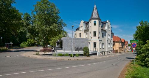 a large white building with a steeple on a street at Cityappartement am Belvedere in Weimar