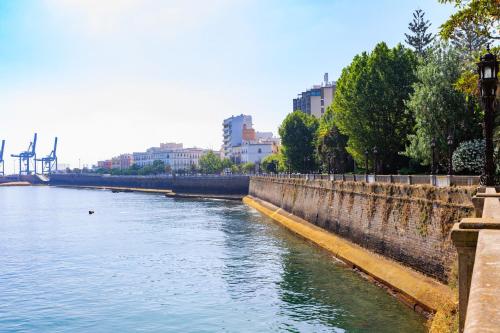 a view of a river with buildings in the background at El CONSEJERO de Indias free parking by Cadiz4Rentals in Cádiz