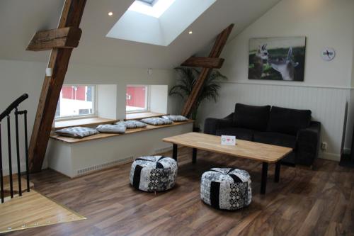 a living room with a couch and a table at Norrängens Alpacka - Det lilla boutiquehotellet med en fluffy twist ! in Sala