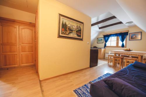 a living room with a couch and a dining room at APARTMENTS ROGLA LUKANJA 1 in Oplotnica