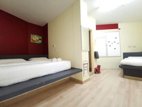 a bedroom with a large bed and a window at Abby by the river in Ipoh