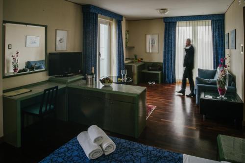 a woman is walking through a living room at Hotel Royal in Fermo