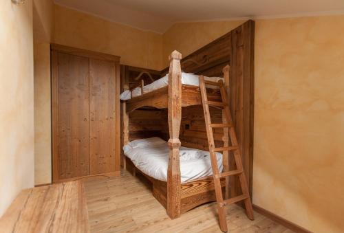 a bunk room with two bunk beds in it at Residence Samont in Arta Terme