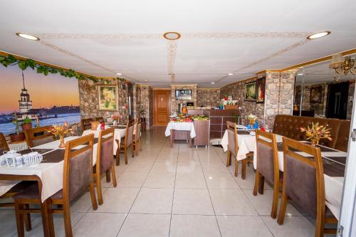 a dining room with tables and chairs in a restaurant at Meddusa Hotel in Istanbul