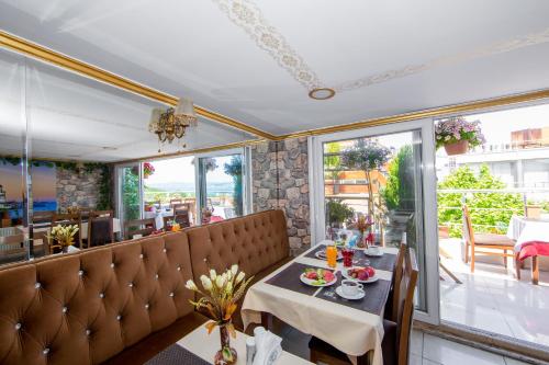 a dining room with a table and chairs and windows at Meddusa Hotel in Istanbul