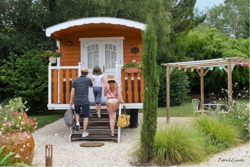a group of people walking out of a tiny house at Logis Hôtel-Restaurant Le Relais in Hauterives