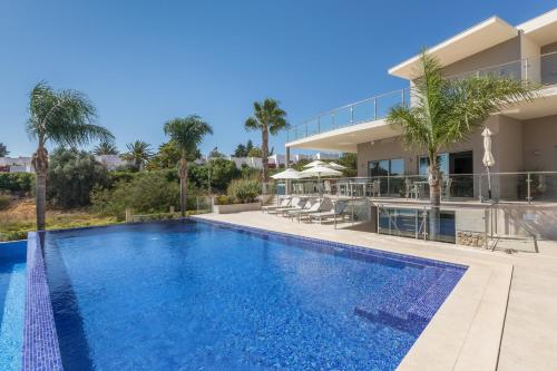 an image of a swimming pool in a villa at Caneiros Luxury House & Suites in Ferragudo