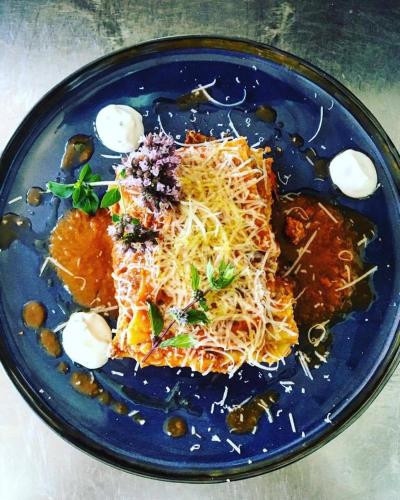 a blue plate of food with pasta and cheese at Die Reinbachstube in Sankt Johann im Pongau