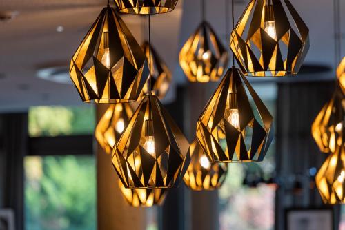 a bunch of lights hanging from a ceiling at HARBR. hotel Konstanz in Konstanz