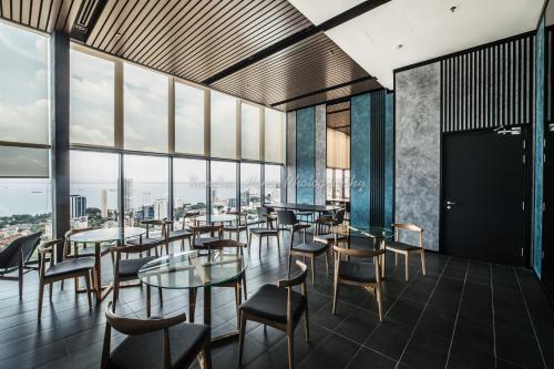 un ristorante con tavoli e sedie e grandi finestre di Xandra's 218 Macalister Suite a George Town