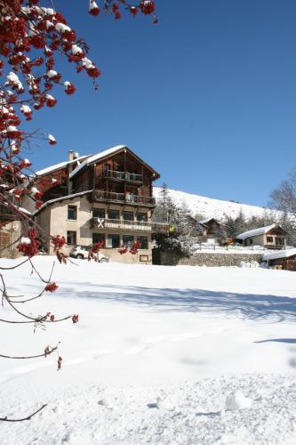a building in the snow with snow at Hotel Le Chamois Logis in Molines-en-Queyras
