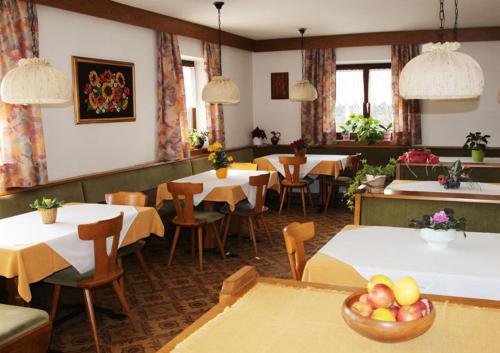 a dining room with tables and chairs and tablesktop at Haus Hafner in Avelengo