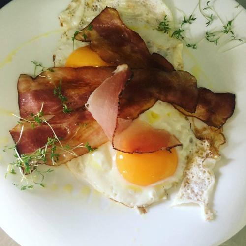 a plate of breakfast food with eggs and bacon at Die Reinbachstube in Sankt Johann im Pongau
