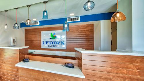 a front desk of a uptown plus store with lights at Uptown Suites Extended Stay Tampa FL - Riverview in Riverview