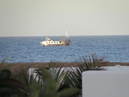 a boat floating on the water in the ocean at MOJACAR HOME AND BEACH in Mojácar