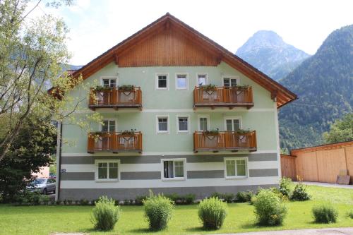 a house with balconies on the side of it at Ferienhof Osl in Obertraun