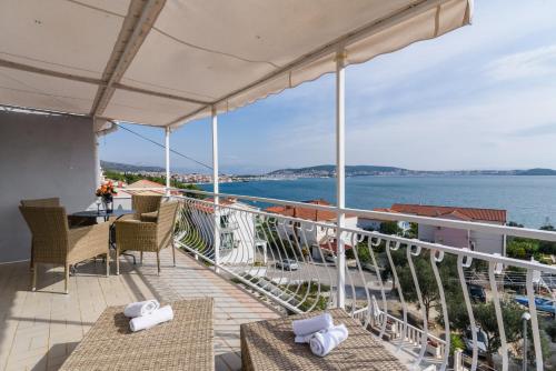 a balcony with a view of the water at La Bodega Apartments in Trogir