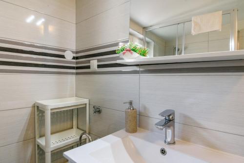 a bathroom with a sink and a mirror at La Bodega Apartments in Trogir