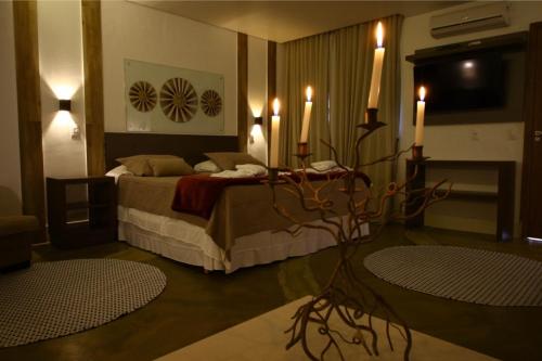 a bedroom with a bed with two rugs in it at Pousada Cristal da Terra in Sao Jorge