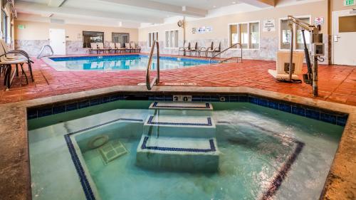 a pool in a hotel room with a swimming pool at Best Western Plus Canyon Pines in Ogden