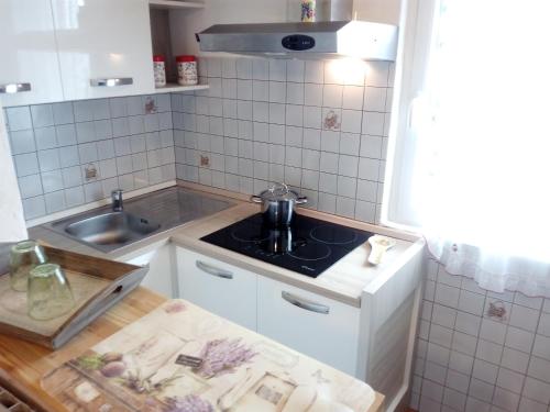 a small kitchen with a sink and a stove at Como Ricky Apartment in Cavallasca