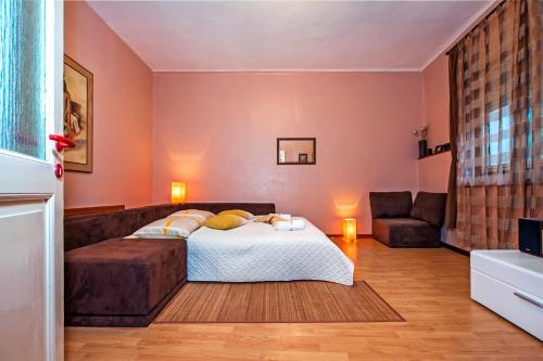 a bedroom with a bed and a couch at STELA - One Bedroom Apartment in Rovinj