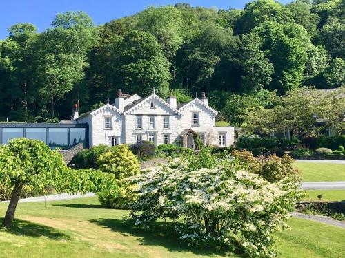 a house with a large garden and trees at The Samling Hotel in Windermere