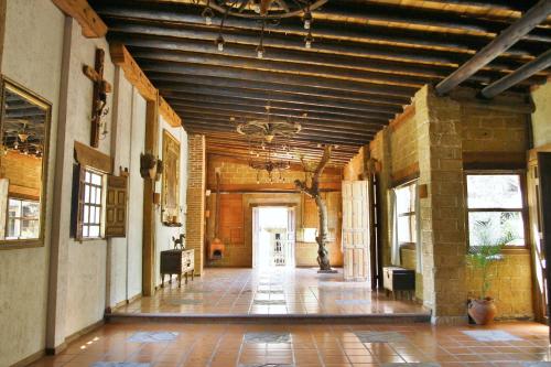 an empty hallway of a building with a ceiling at Hotel Hacienda Don Juan in San Cristóbal de Las Casas