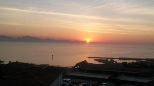 a sunset over the water with the sun in the sky at Beth-El in Mossel Bay