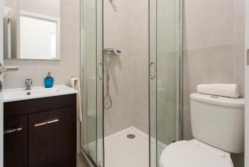 a bathroom with a shower and a toilet and a sink at Central Downtown by Central Hill Apartments in Lisbon