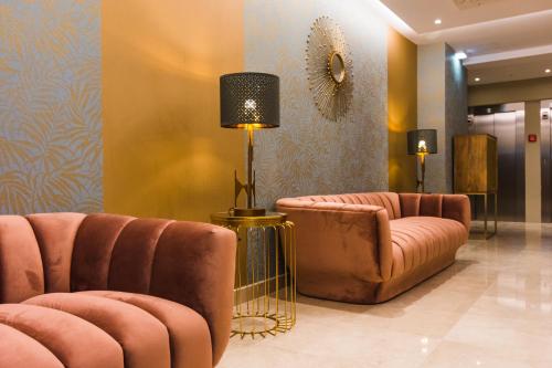 a lobby with two couches and a lamp and chairs at Rossio Boutique Hotel in Lisbon