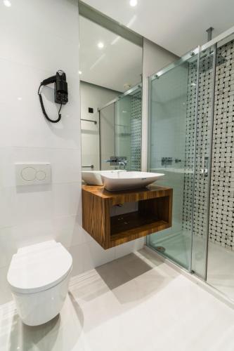a bathroom with a toilet and a sink and a shower at Rossio Boutique Hotel in Lisbon